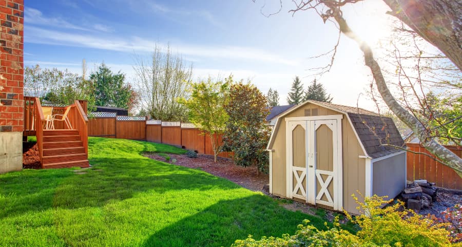 Fenced backyard with storage shed in Sugarland